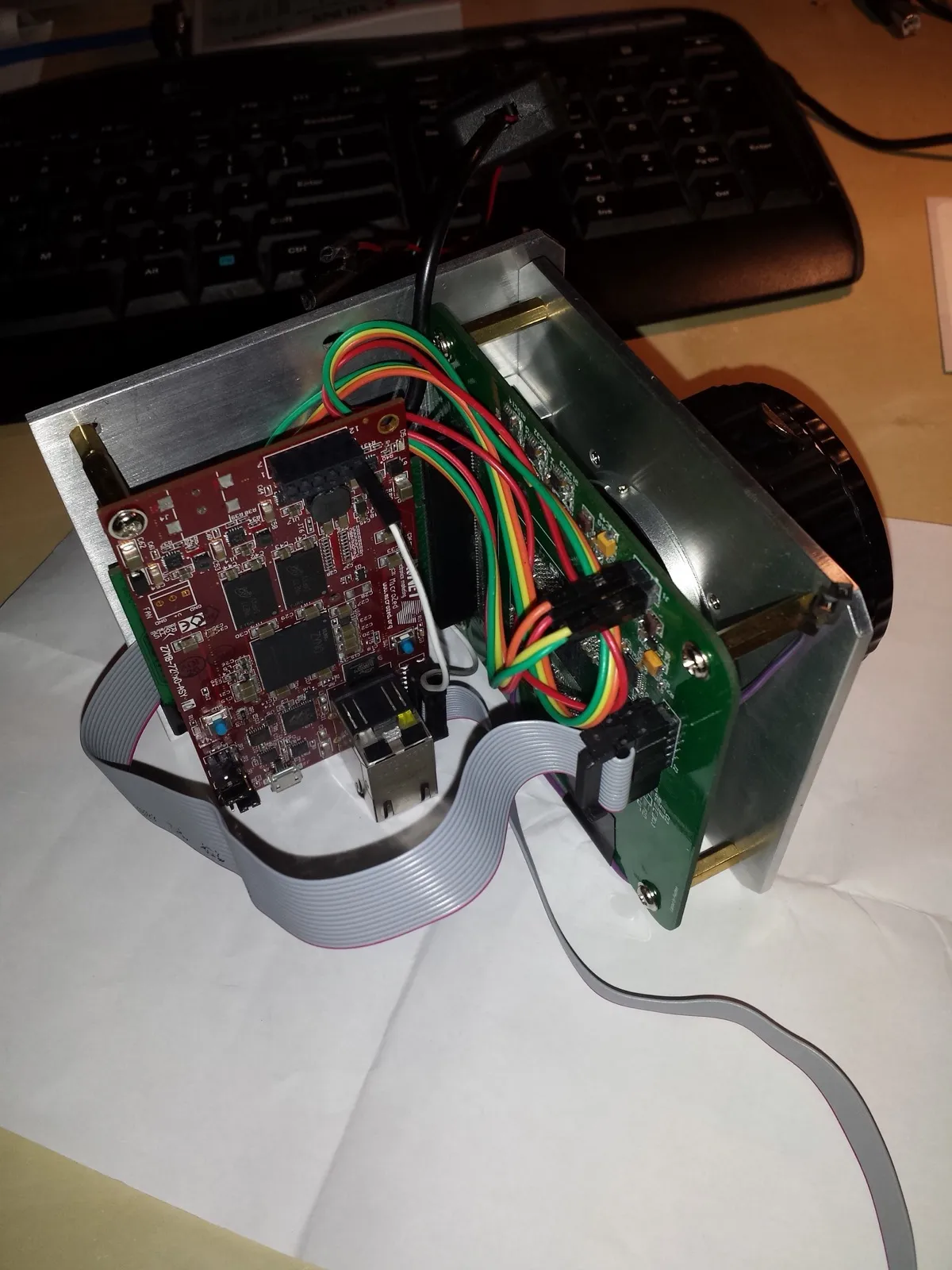 An early hand-built astronomy camera with an exposed FPGA board and ribbon cables