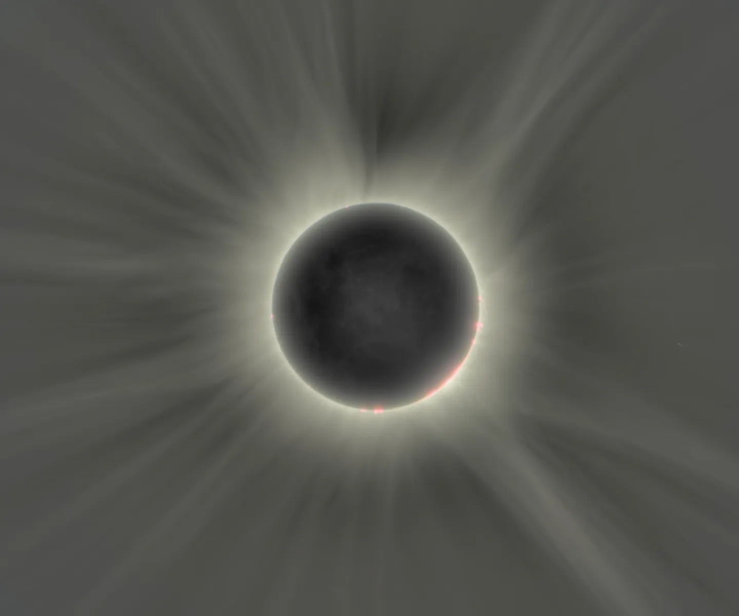 A total solar eclipse image showing the Moon, solar corona, and faint outer structures captured with high dynamic range detail.