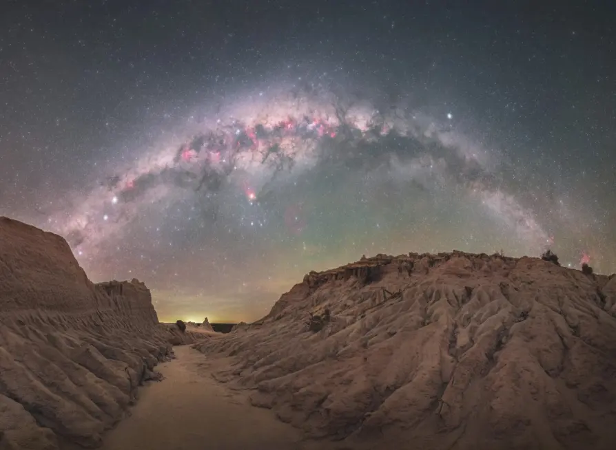 Wide nightscape sample with the Milky Way arching over a desert canyon